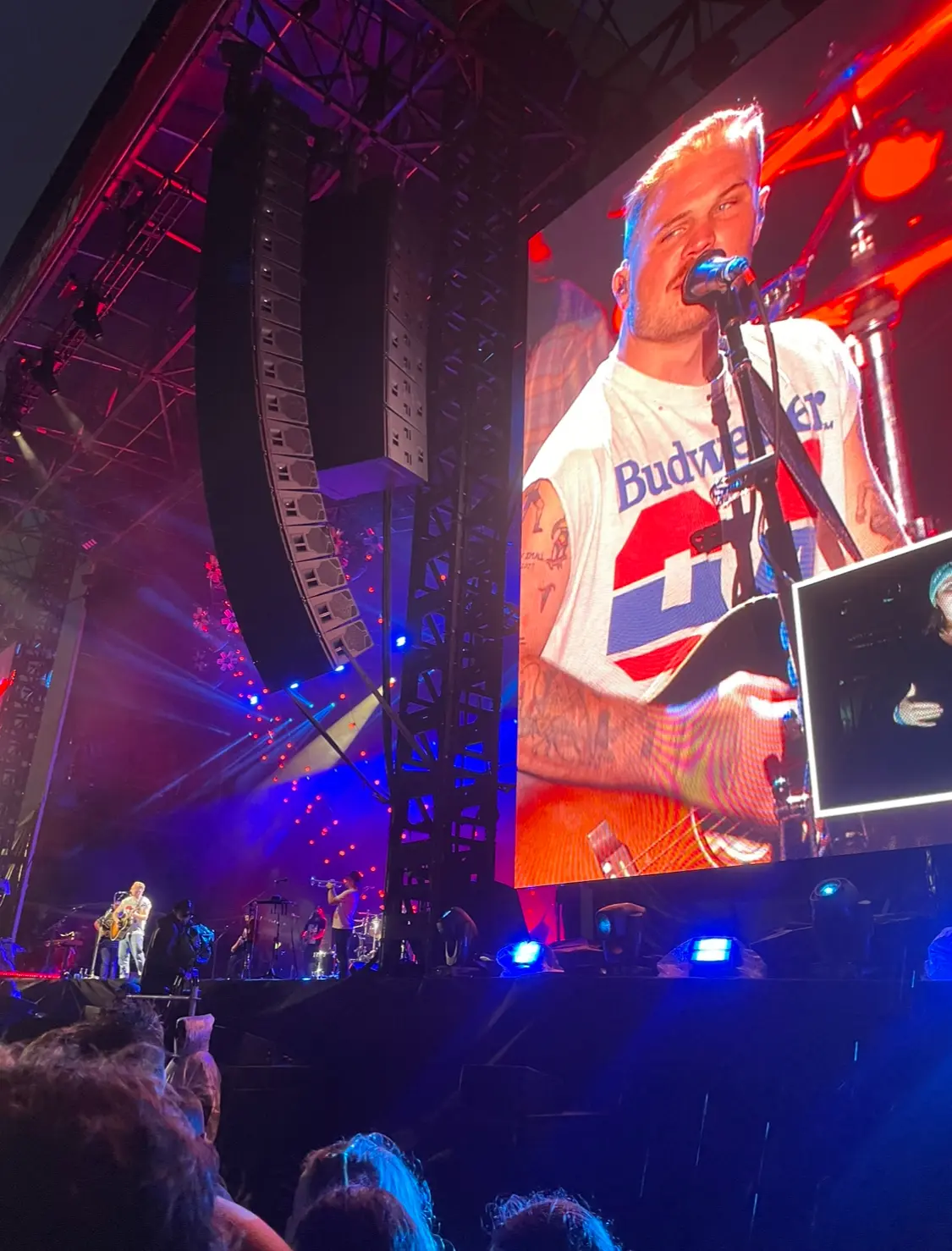 Zach Bryan on stage and on a large video screen during his Melbourne concert in December 2023.